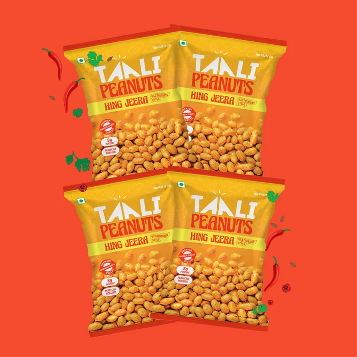 Taali Roasted Peanuts in Hing Jeera, retail packs fanned out on a flat colour tile